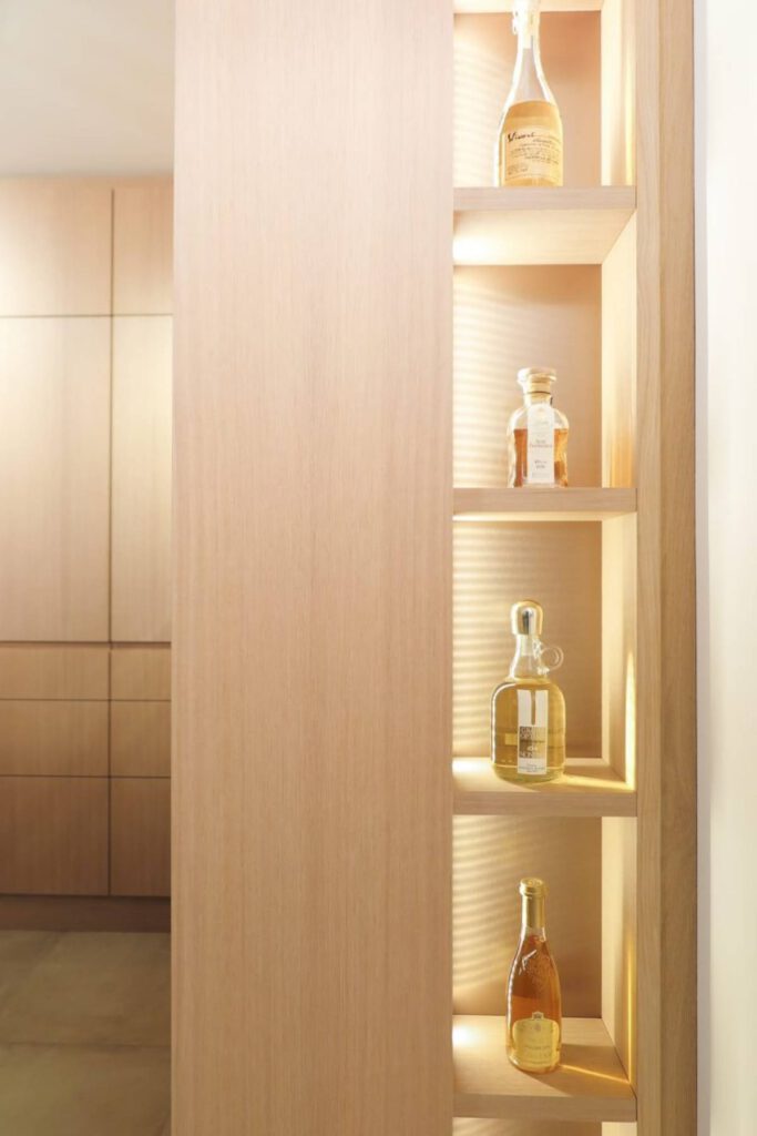 Beleuchtetes Flaschenregal in Eichen-Hochschrank neben Küchenfronten im Haus R in Kassel